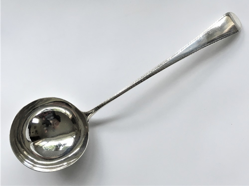 A fine small Georgian silver soup ladle