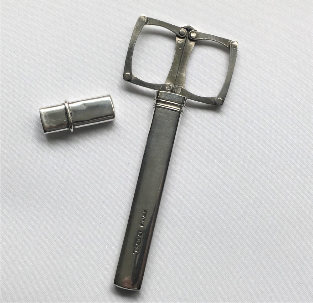 A rare pair of silver cased folding campaign scissors View V