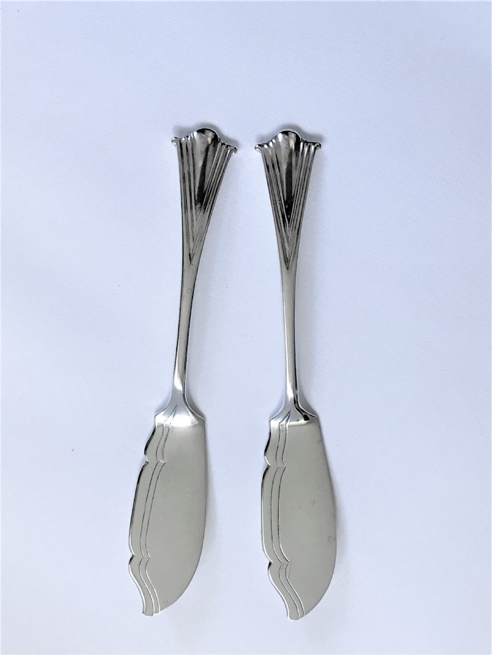 A delightful pair of Onslow pattern Victorian silver butter knives 