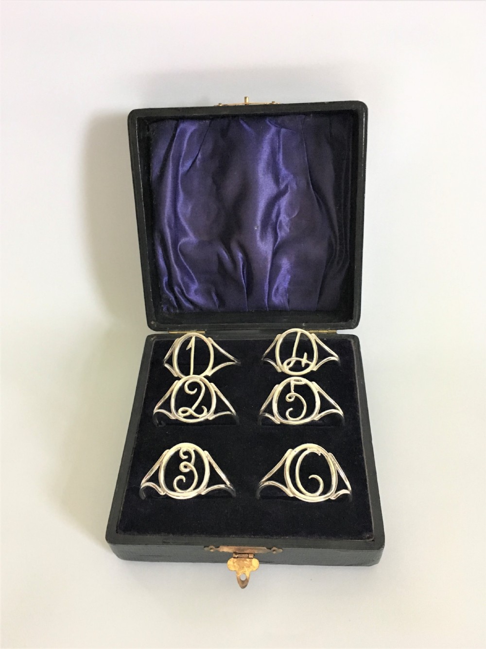 A superb set of six boxed Edwardian silver napkin rings