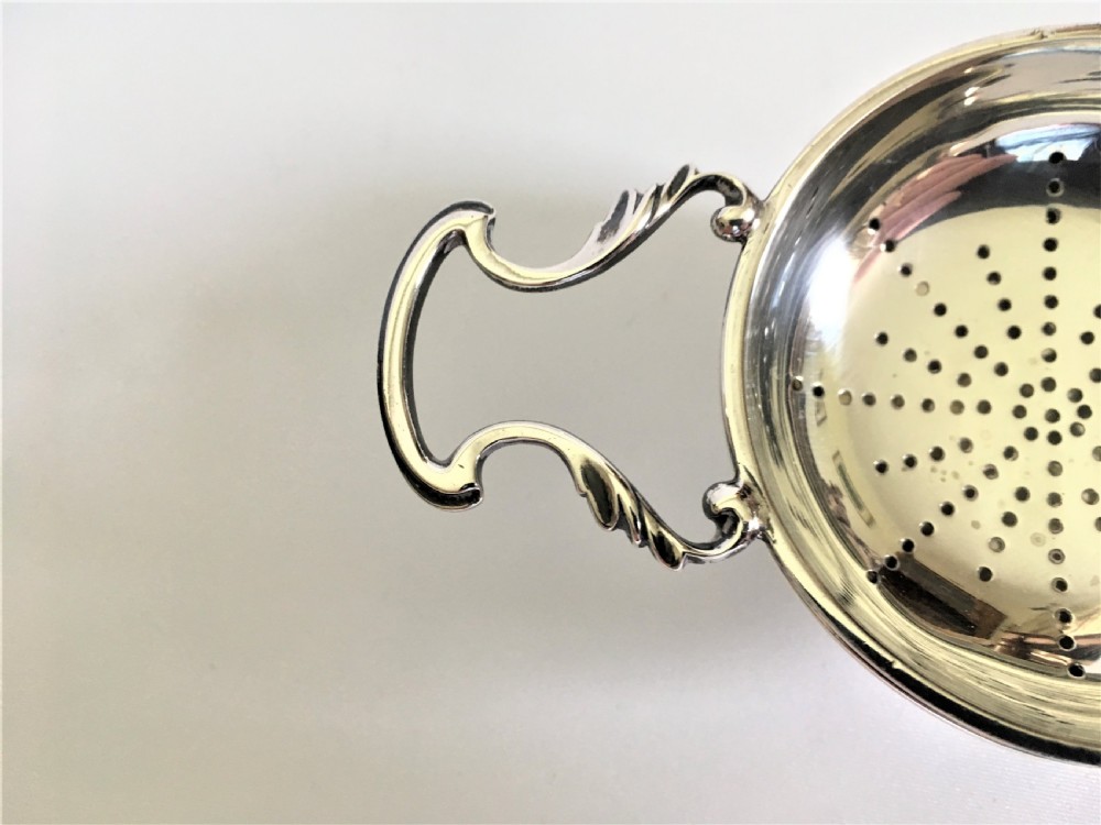  A William Comyns silver tea strainer & drip cup View III