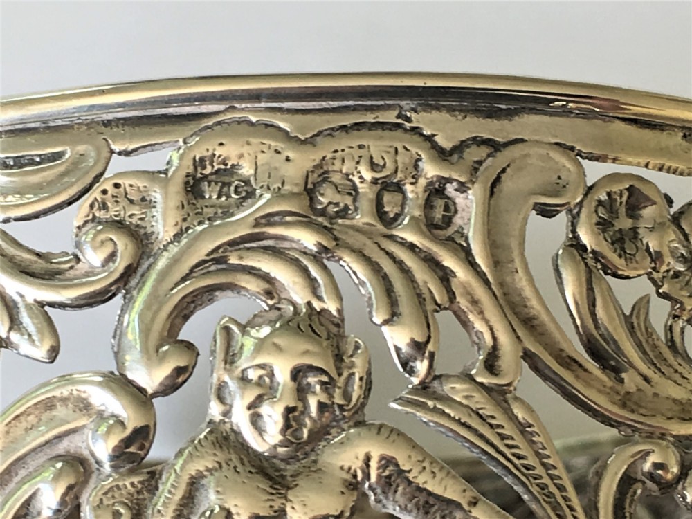 A fabulous William Comyns pierced silver wine bottle coaster View III