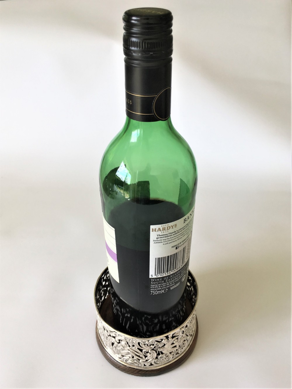 A fabulous William Comyns pierced silver wine bottle coaster View V