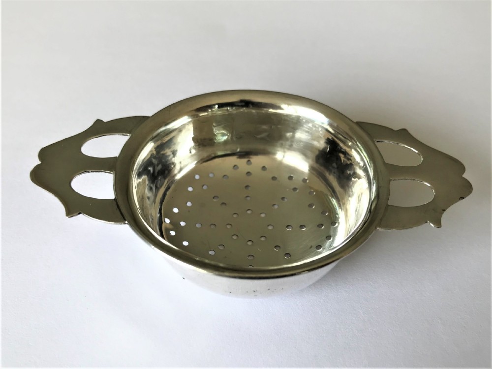 A stylish silver tea strainer in the Art Nouveau style View II