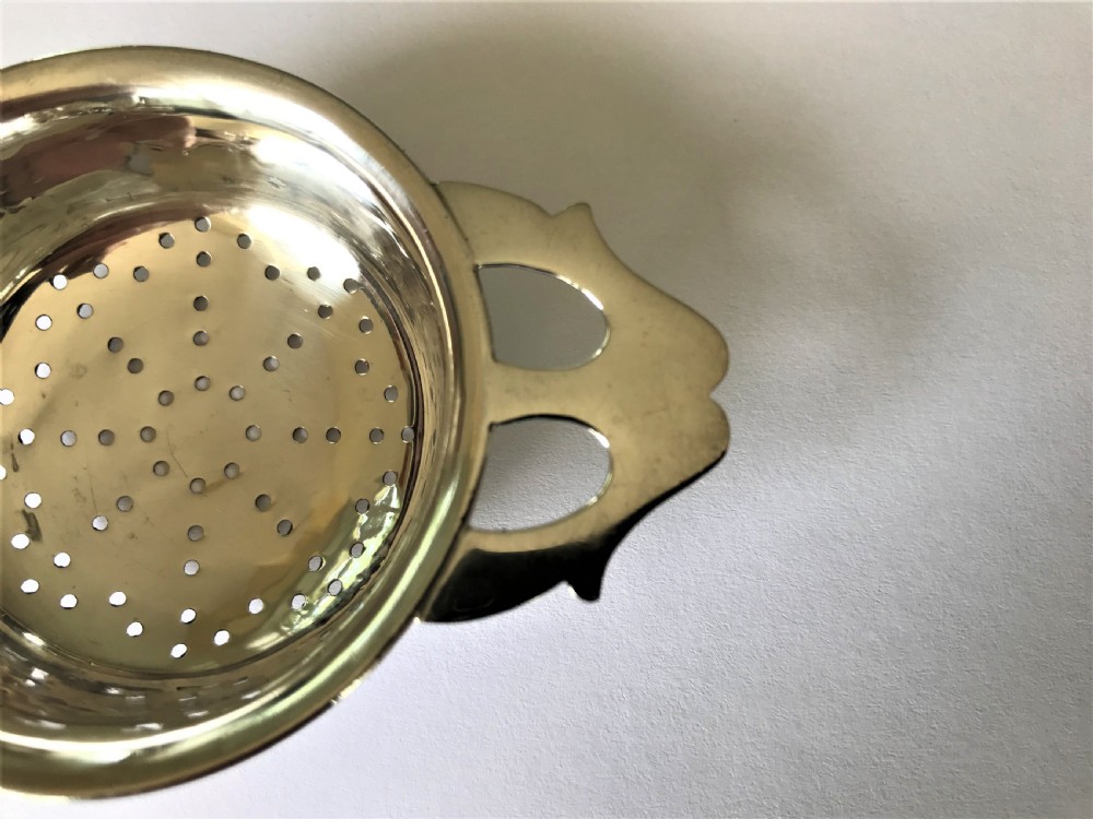 A stylish silver tea strainer in the Art Nouveau style View III