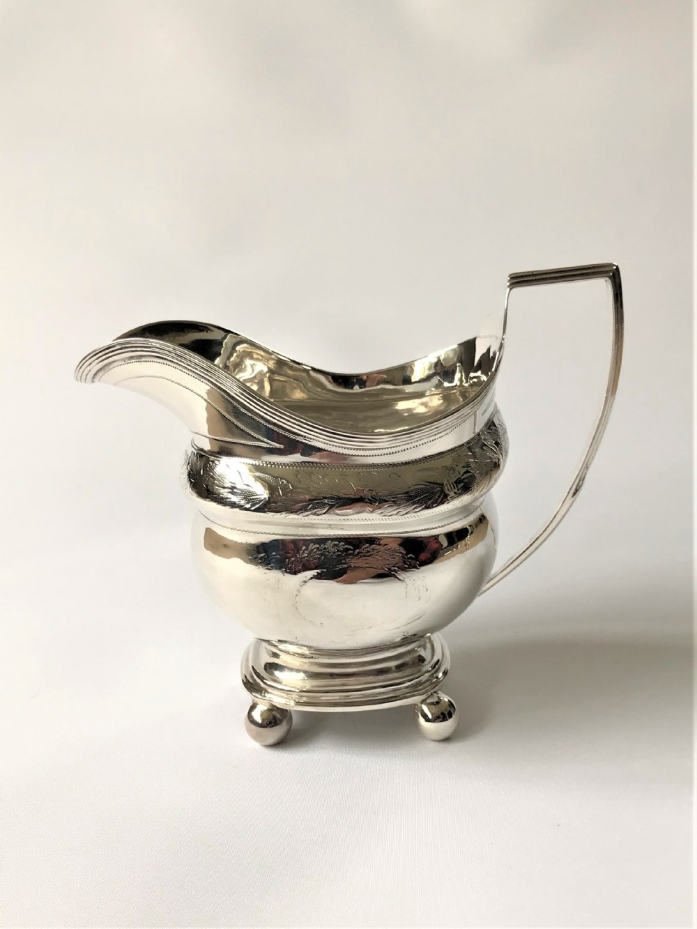 A Georgian Newcastle silver cream jug by a female silversmith