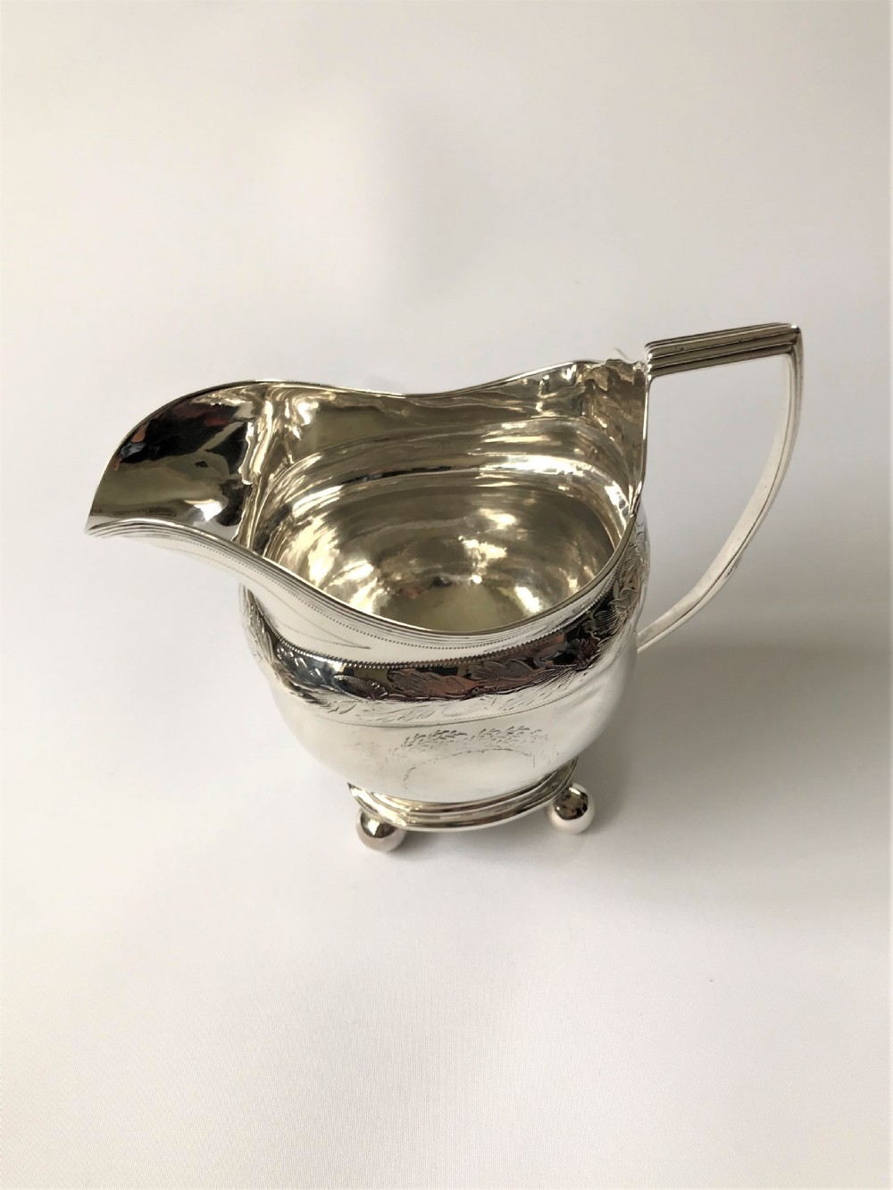 A Georgian Newcastle silver cream jug by a female silversmith View II