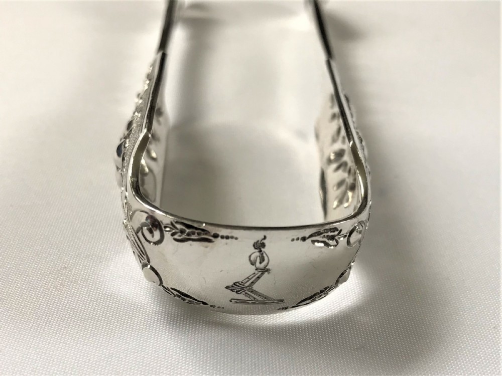 A fabulous pair of cast Irish silver tongs View III