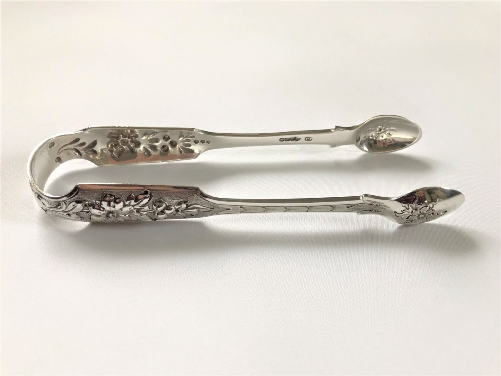 A fabulous pair of cast Irish silver tongs View V