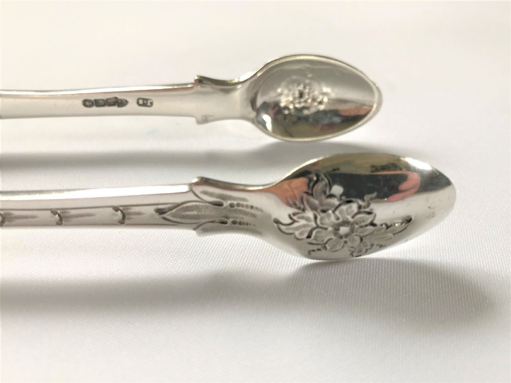 A fabulous pair of cast Irish silver tongs View VI