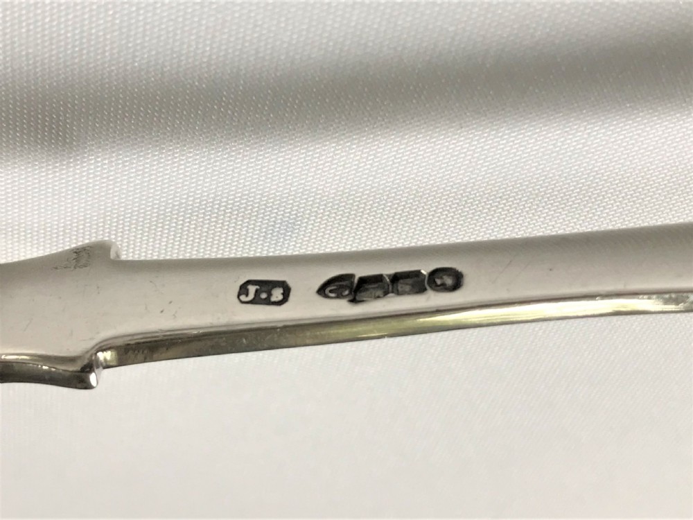 A fabulous pair of cast Irish silver tongs View VII