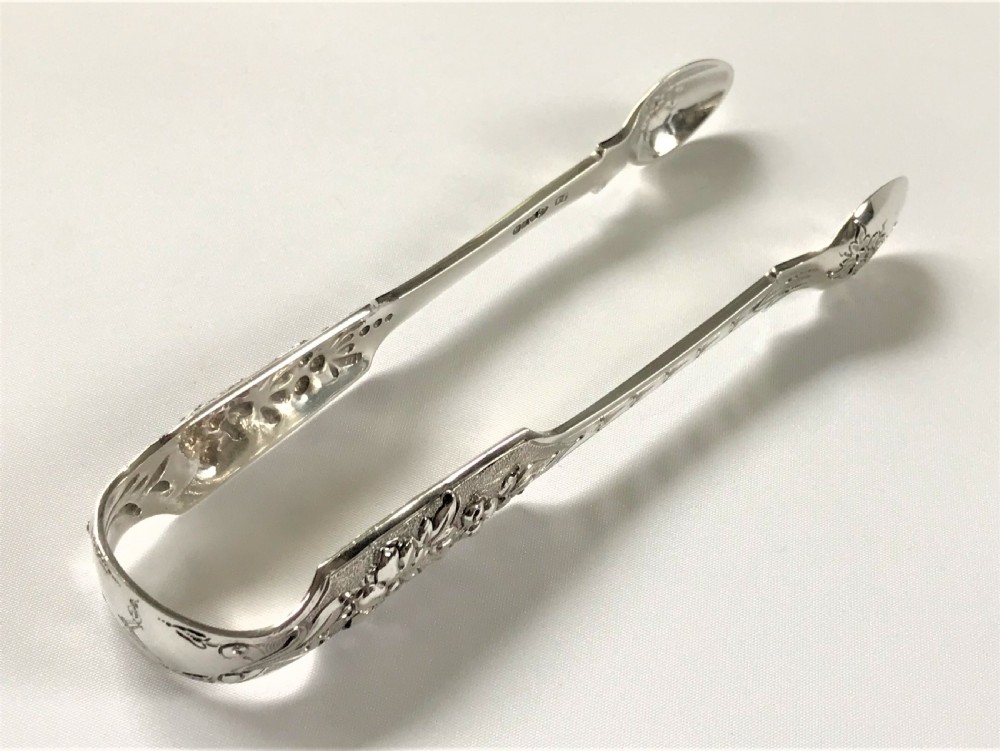 A fabulous pair of cast Irish silver tongs View VIII