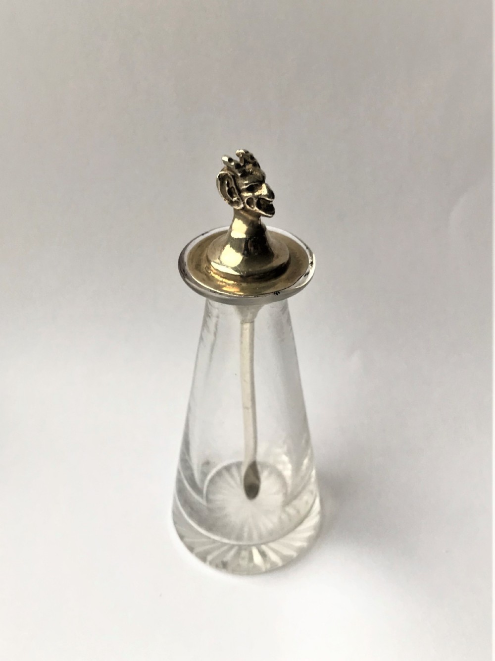 A desirable silver & glass 'devil's head' cayenne bottle & spoon