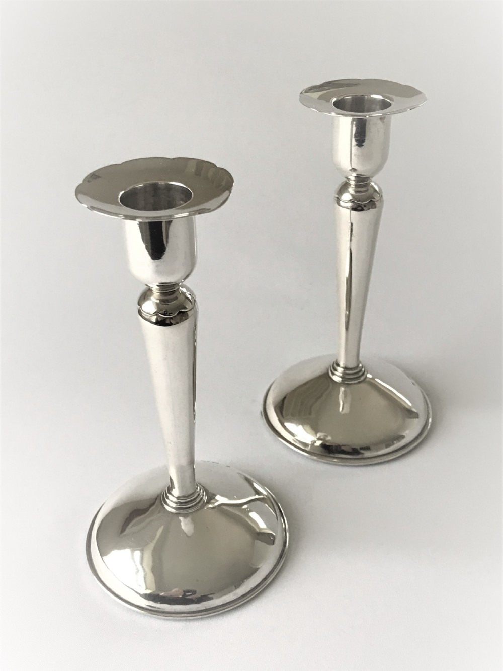 A stylish pair of Coronation mark silver candle sticks