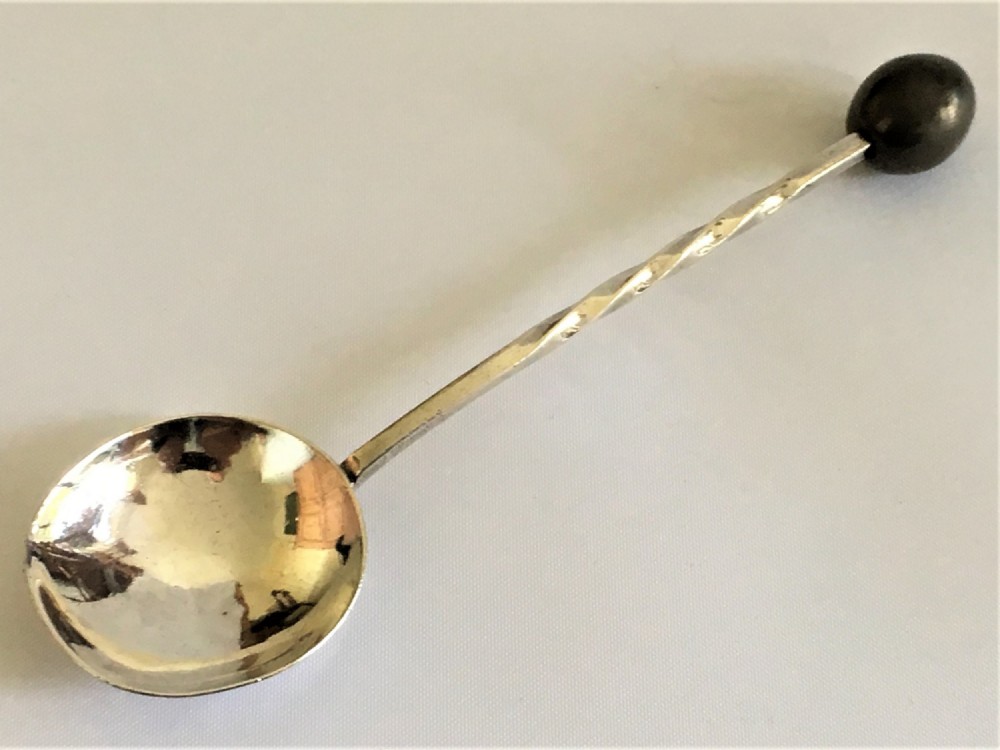 A rare A E Jones Arts & Crafts silver olive spoon