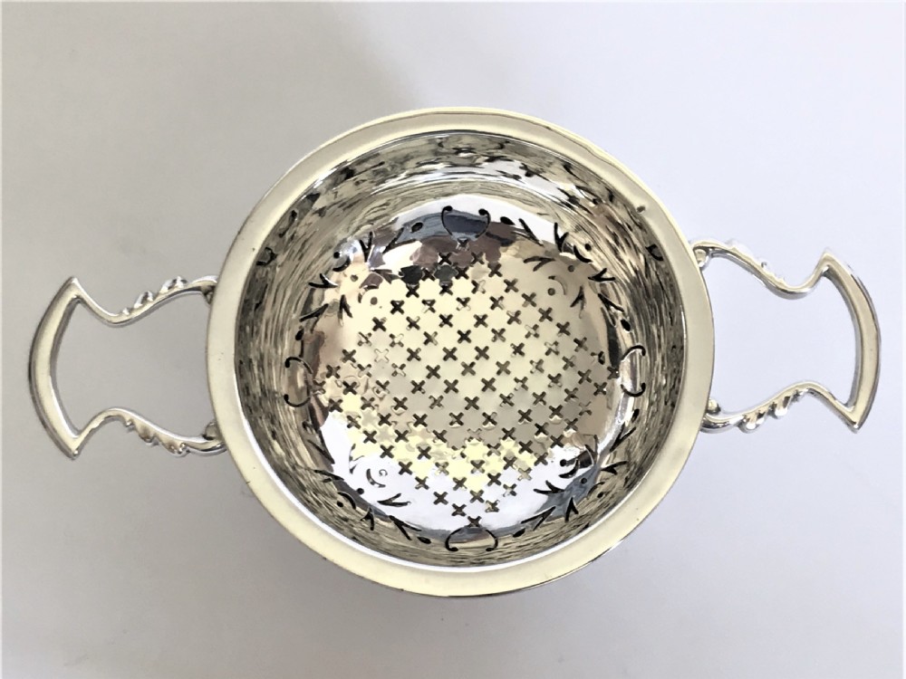 A superb silver tea strainer & drip cup View VIII