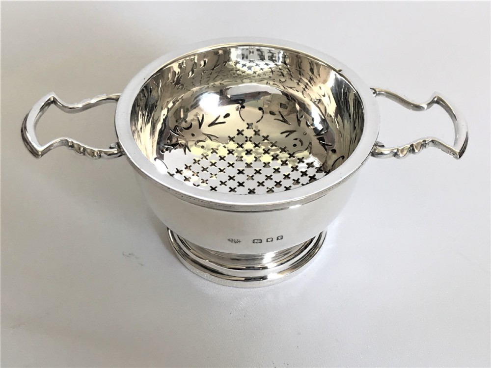 A superb silver tea strainer & drip cup View IX