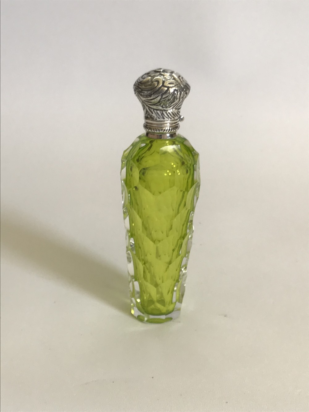 A gorgeous acid green Victorian silver mounted scent bottle