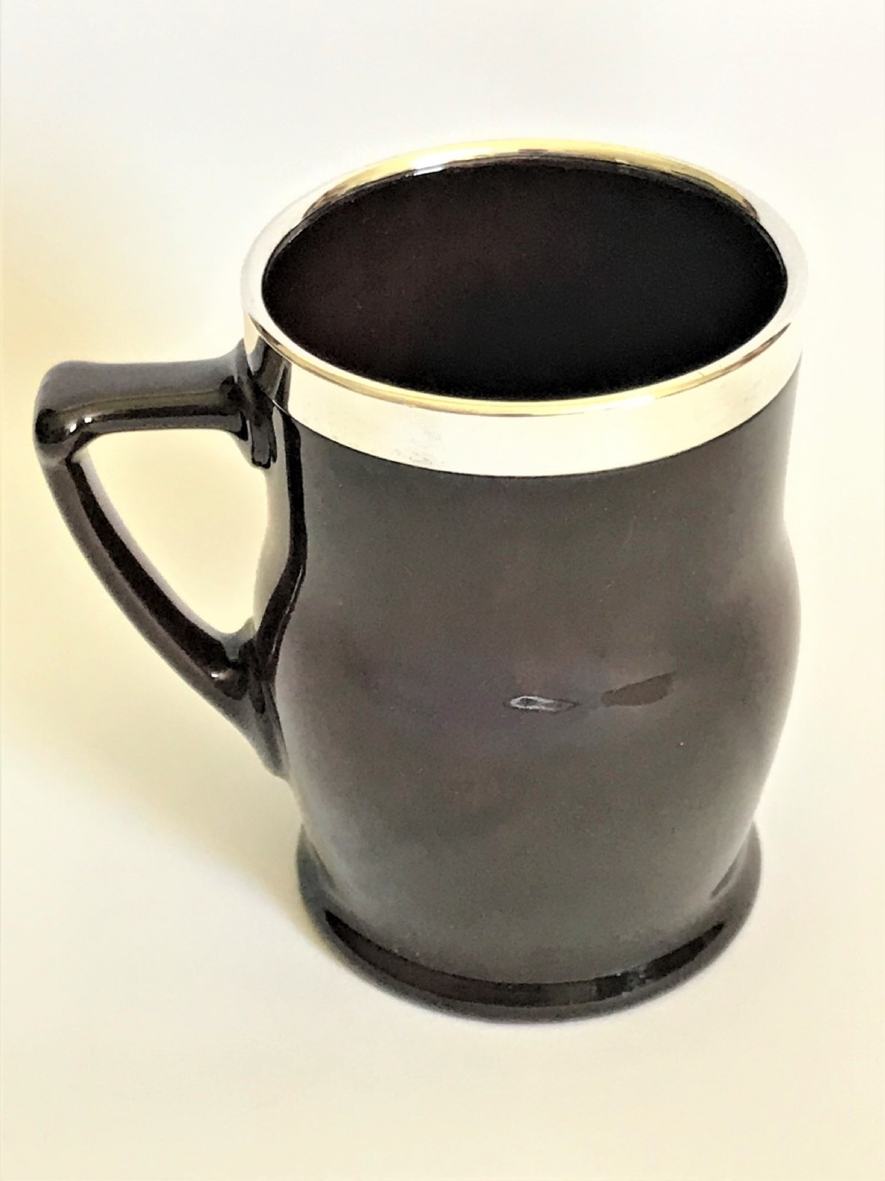 An Edwardian silver mounted Royal Doulton tankard View V