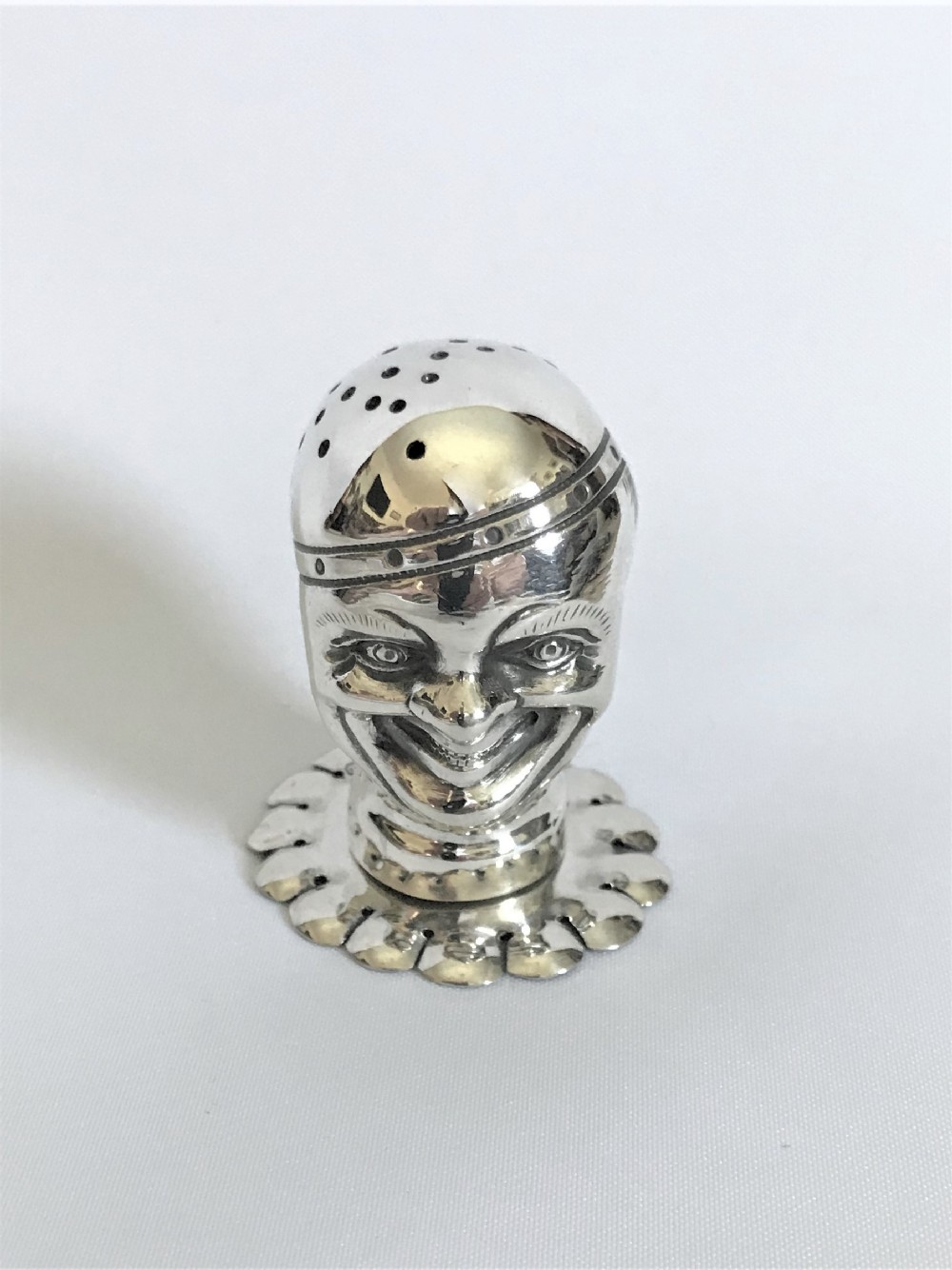 An extraordinary Victorian silver novelty clown pepper pot 