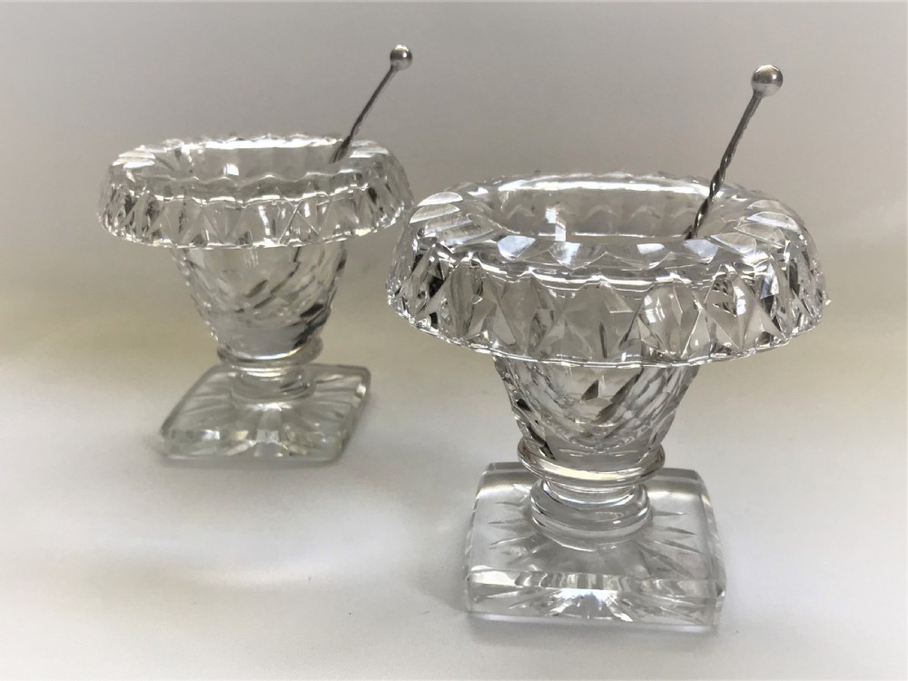 A pair of cut glass Victorian condiment bowls with silver spoons