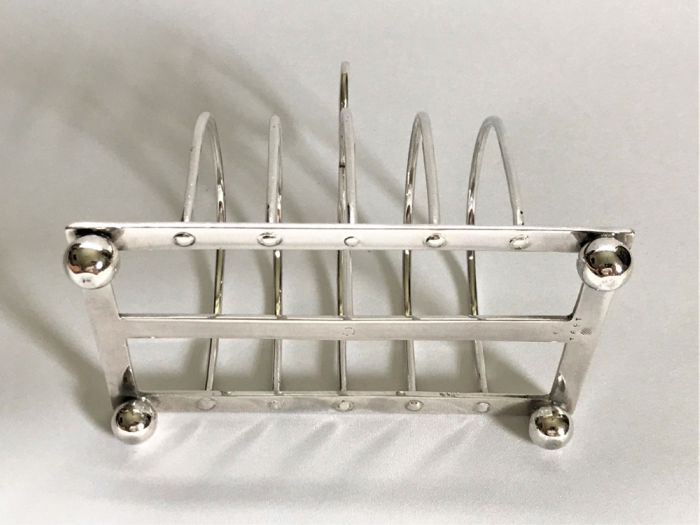 A charming four slice silver toast rack View IV