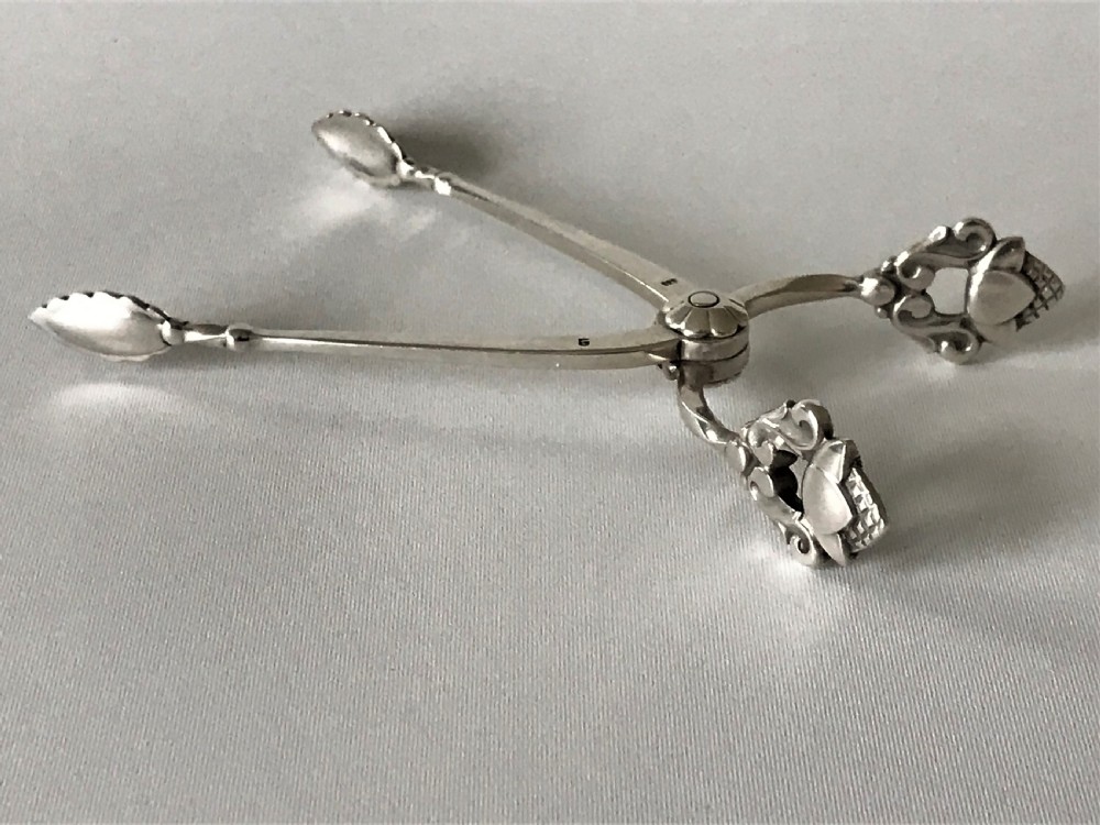 A Fine Pair Of Acorn Pattern Georg Jensen Silver Sugar Nips