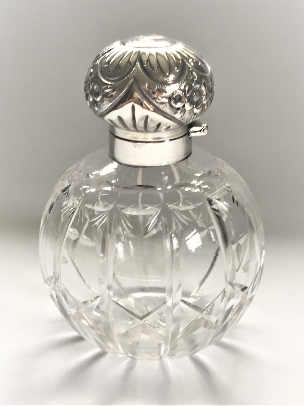 An Edwardian silver mounted cologne bottle