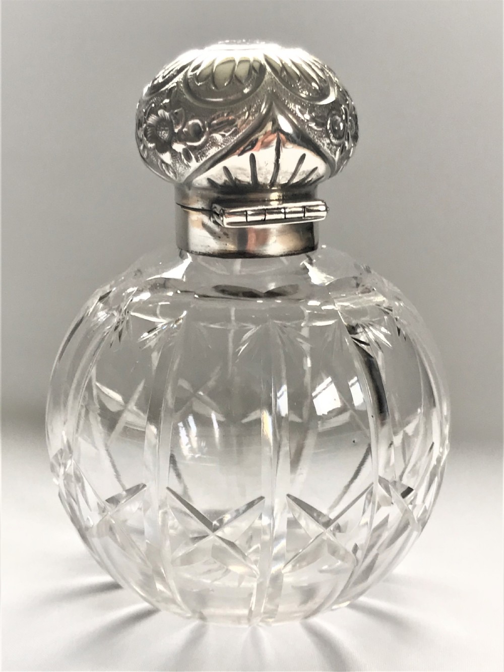 An Edwardian silver mounted cologne bottle View II