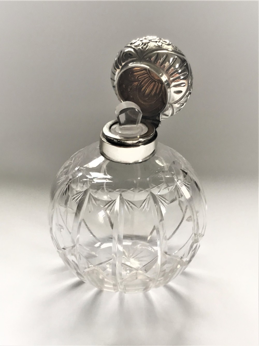 An Edwardian silver mounted cologne bottle View V