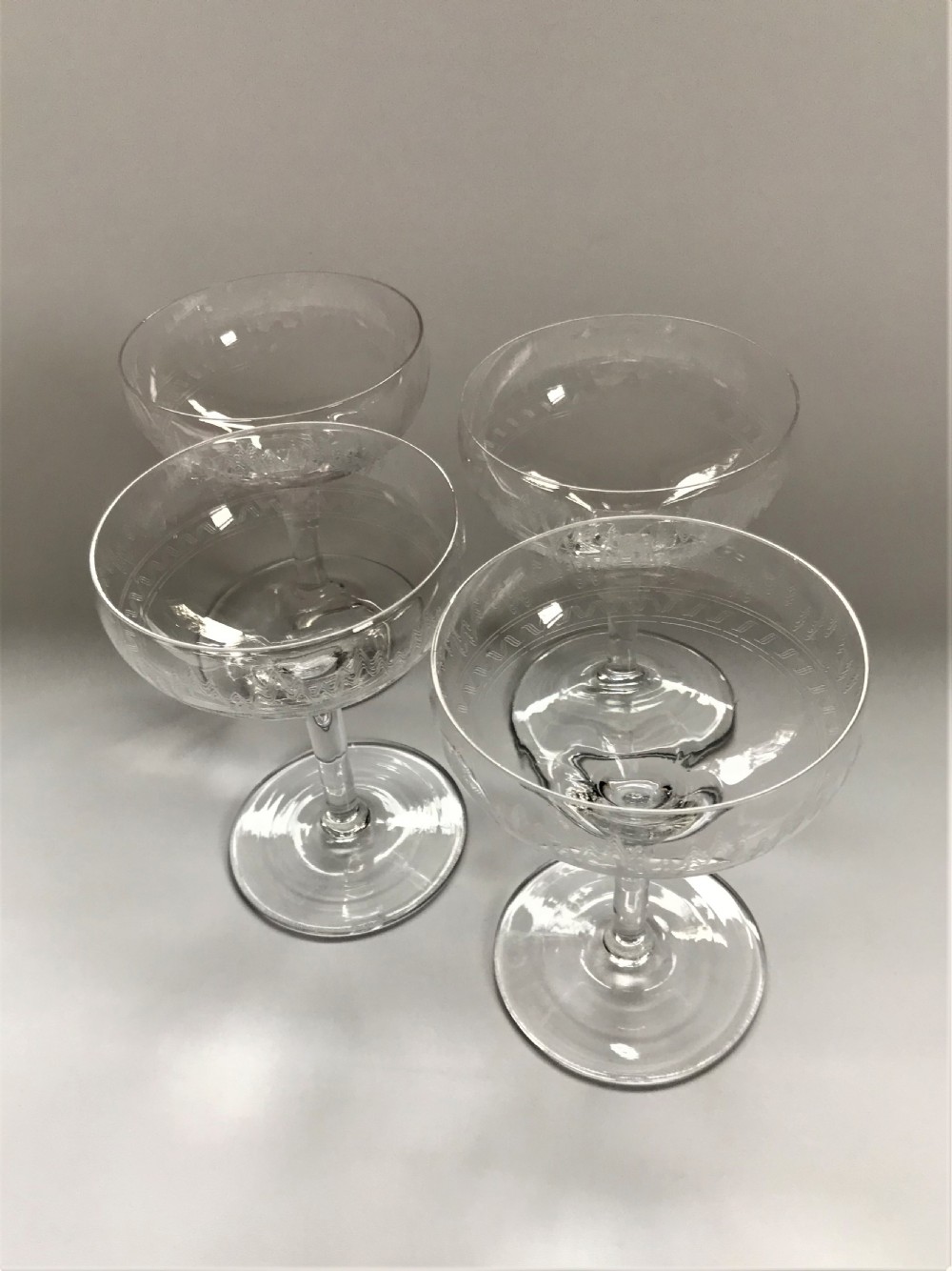 A set of 4 etched champagne bowls