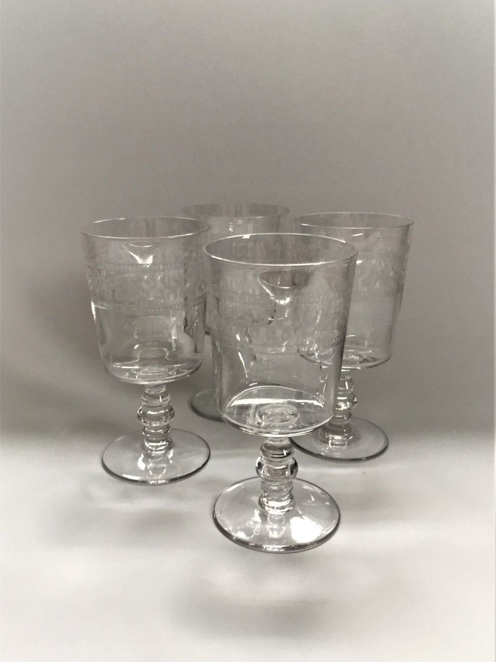 A good set of 4 etched wine goblets