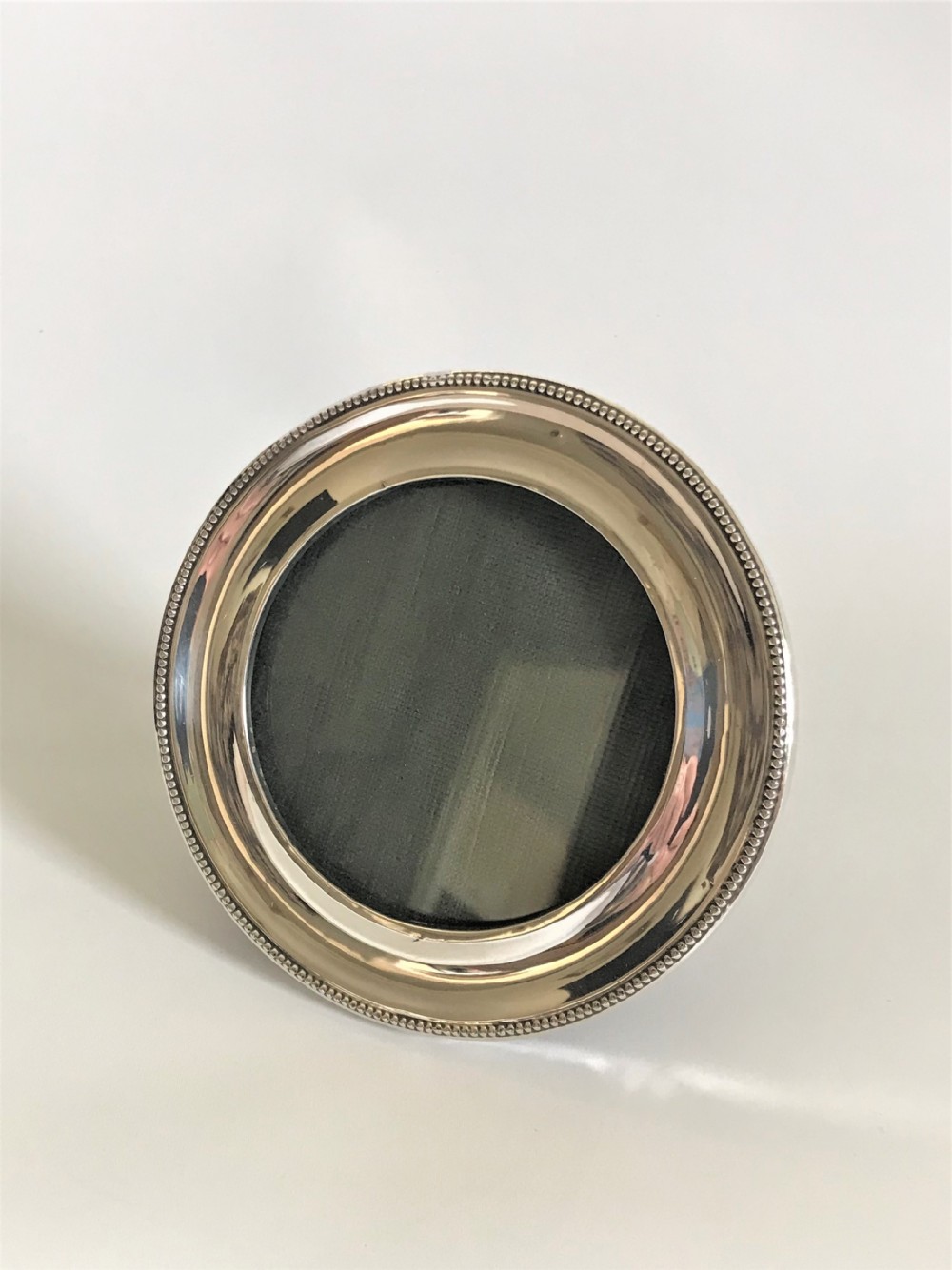 A round George V silver photo frame