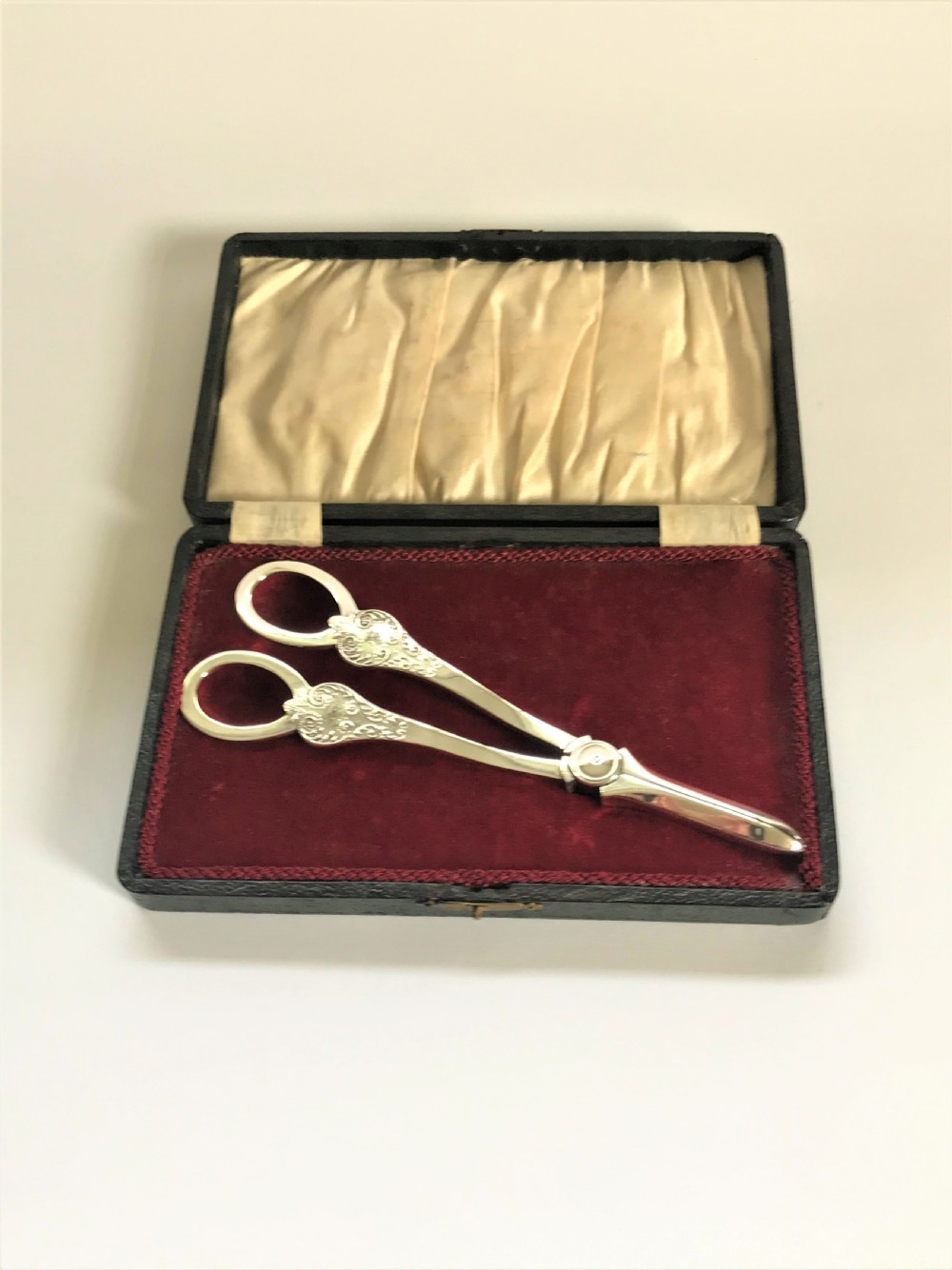 A boxed pair of Mappin & Webb silver grape shears
