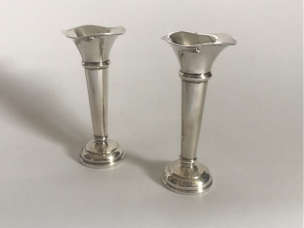A charming pair of small silver bud vases