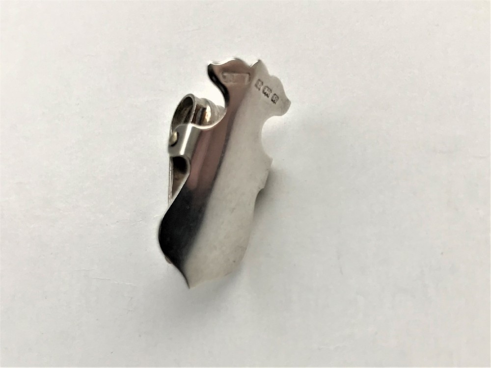 An Edwardian silver 'shield' napkin clip View V