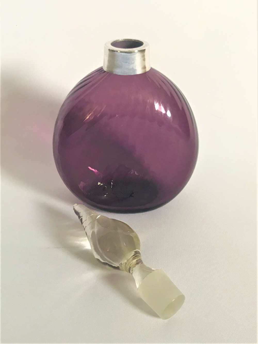A silver mounted amethyst glass cologne bottle View III