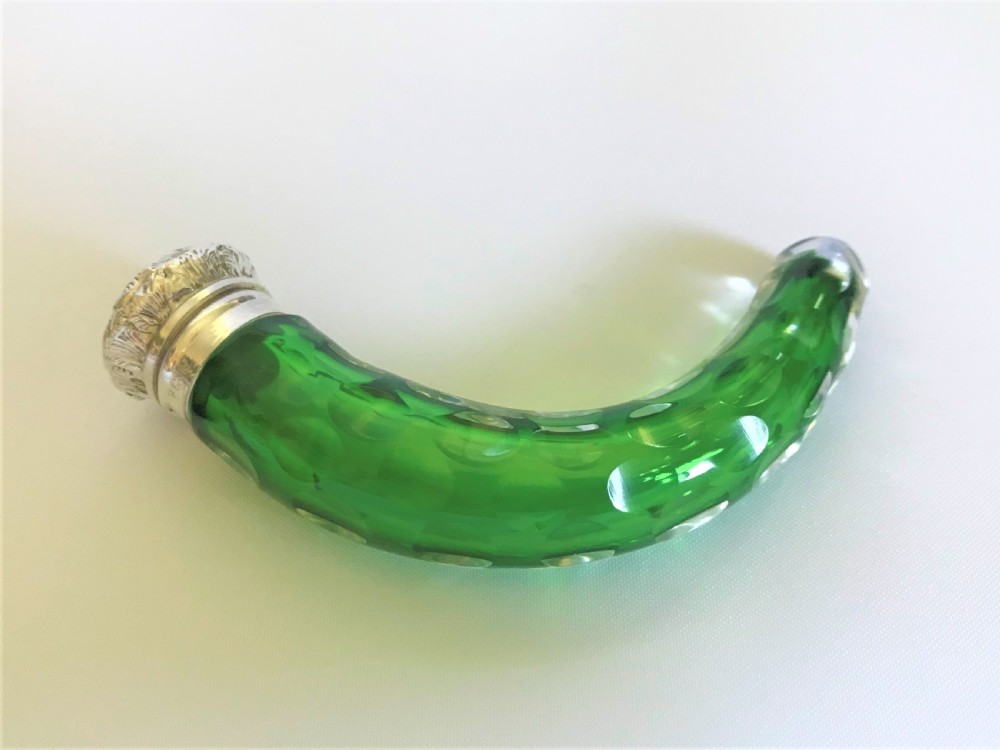 An Edwardian silver mounted 'cornucopia' emerald green scent bottle
