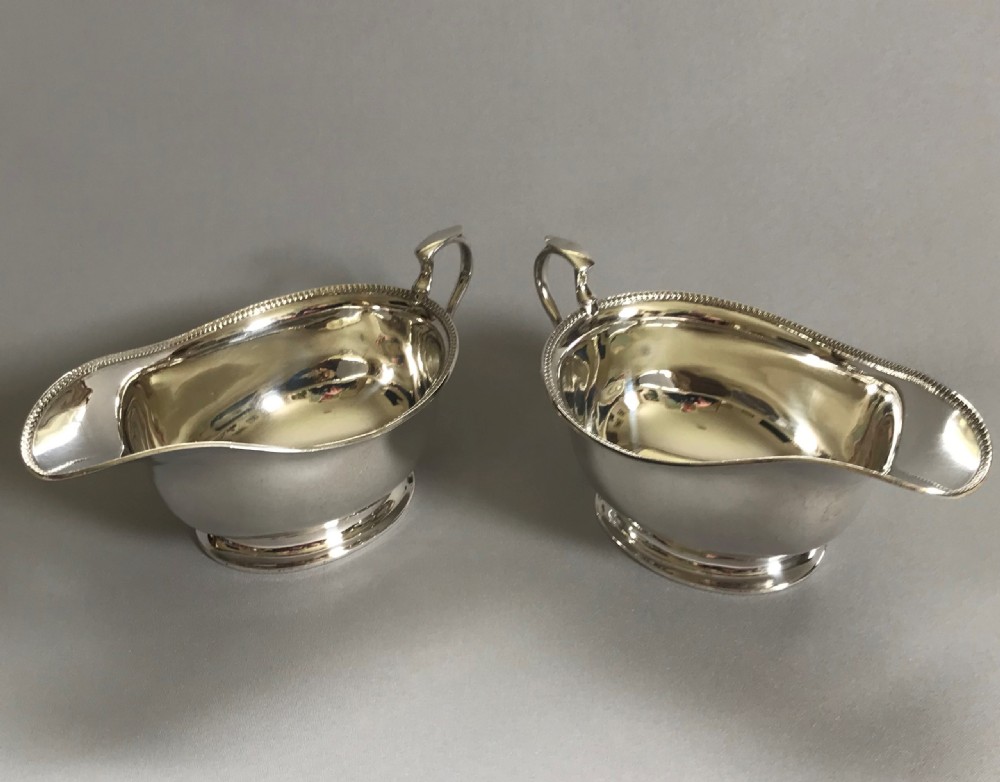 A stylish pair of Art Deco silver gravy boats