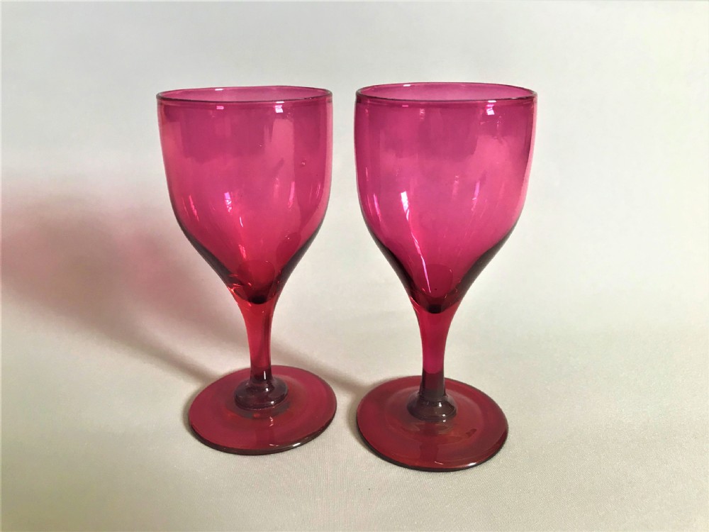 A rare pair of Victorian cranberry wine glasses View III