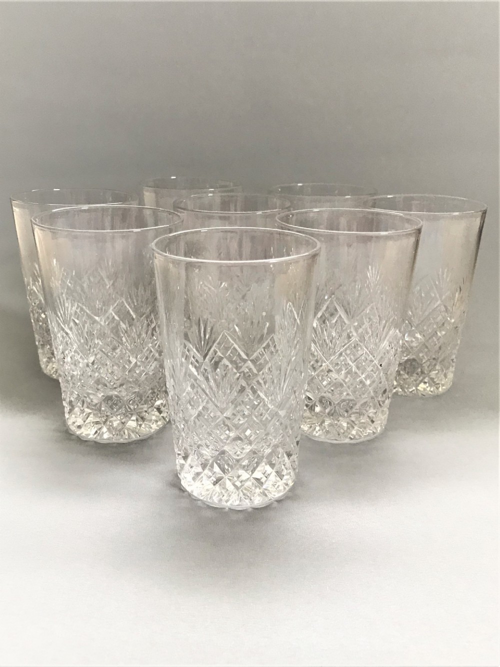 A superior set of 8 good quality cut glass water tumblers