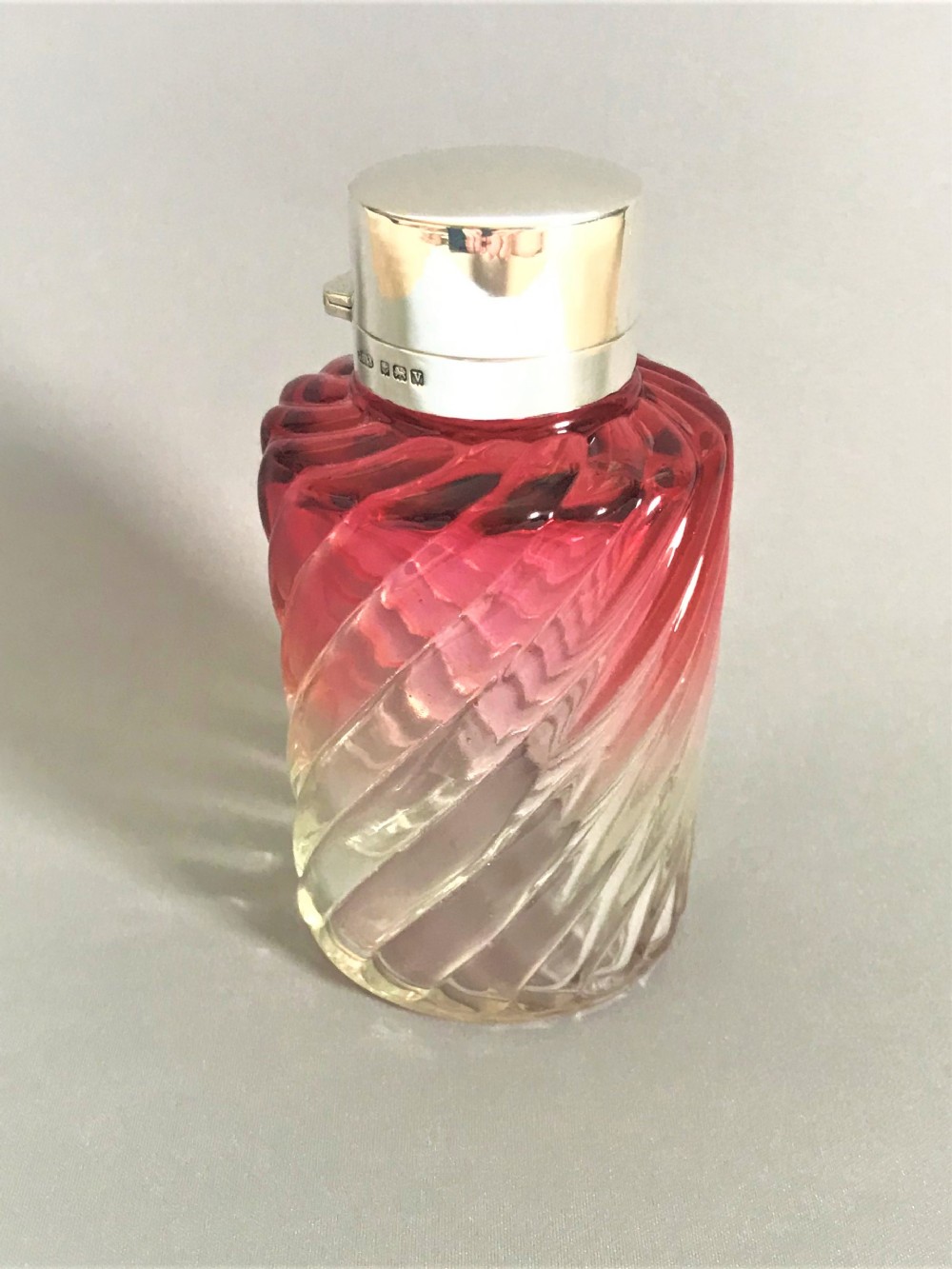 A silver mounted & cranberry glass cologne bottle