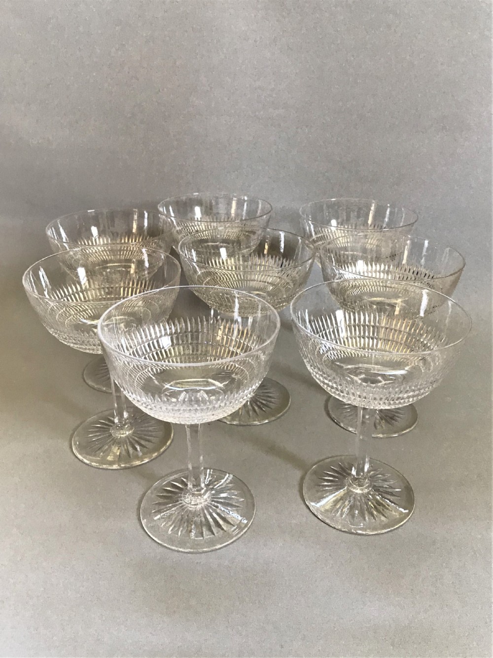 A fine set of 8 cut glass Edwardian champagne bowls