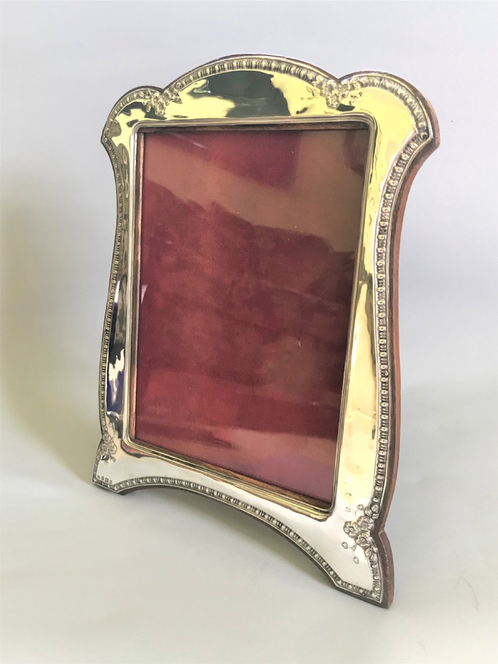 A large George V silver photo frame