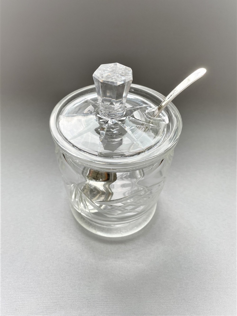A cut glass Edwardian preserve jar with hallmarked silver spoon View II