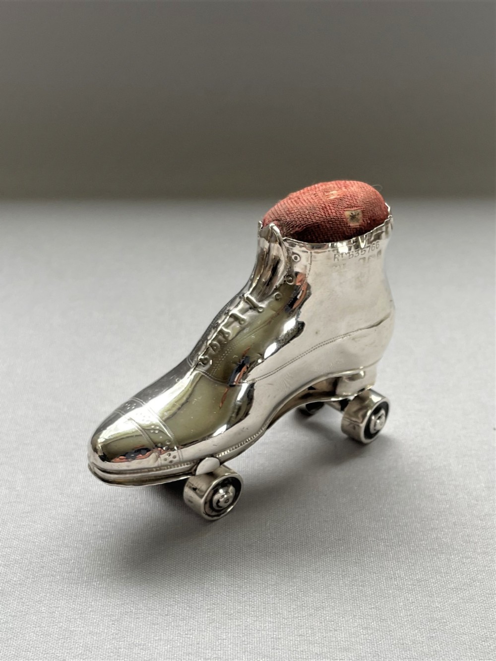 An extremely rare Edwardian silver roller skate pin cushion