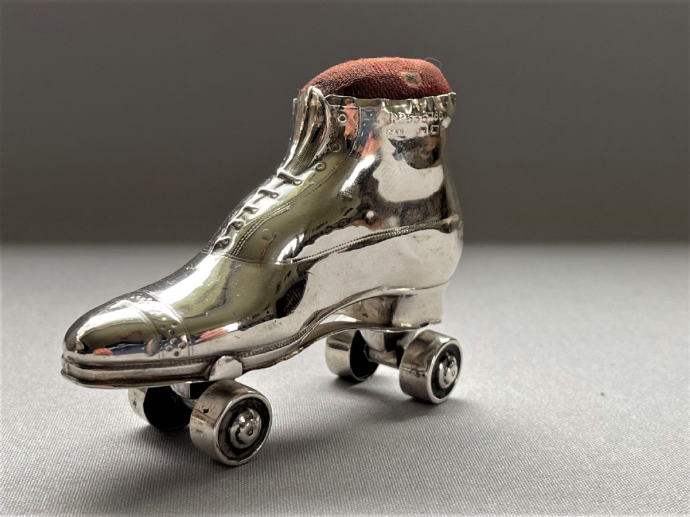 An extremely rare Edwardian silver roller skate pin cushion View II