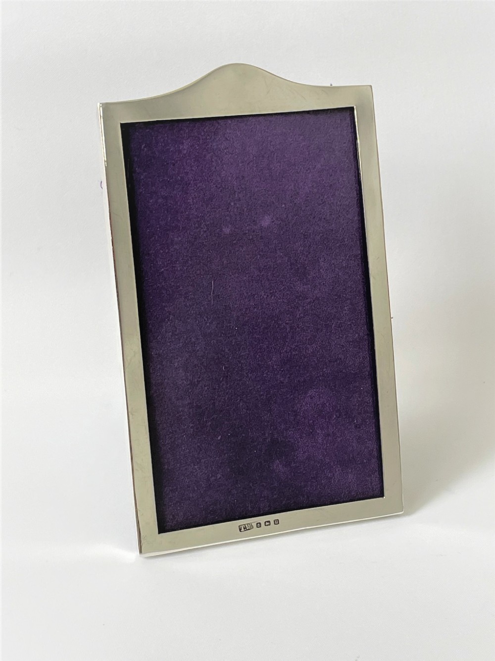 A small silver portrait photo frame