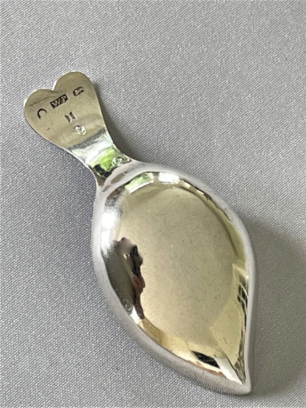 A Georgian silver leaf caddy spoon with heart handle View V