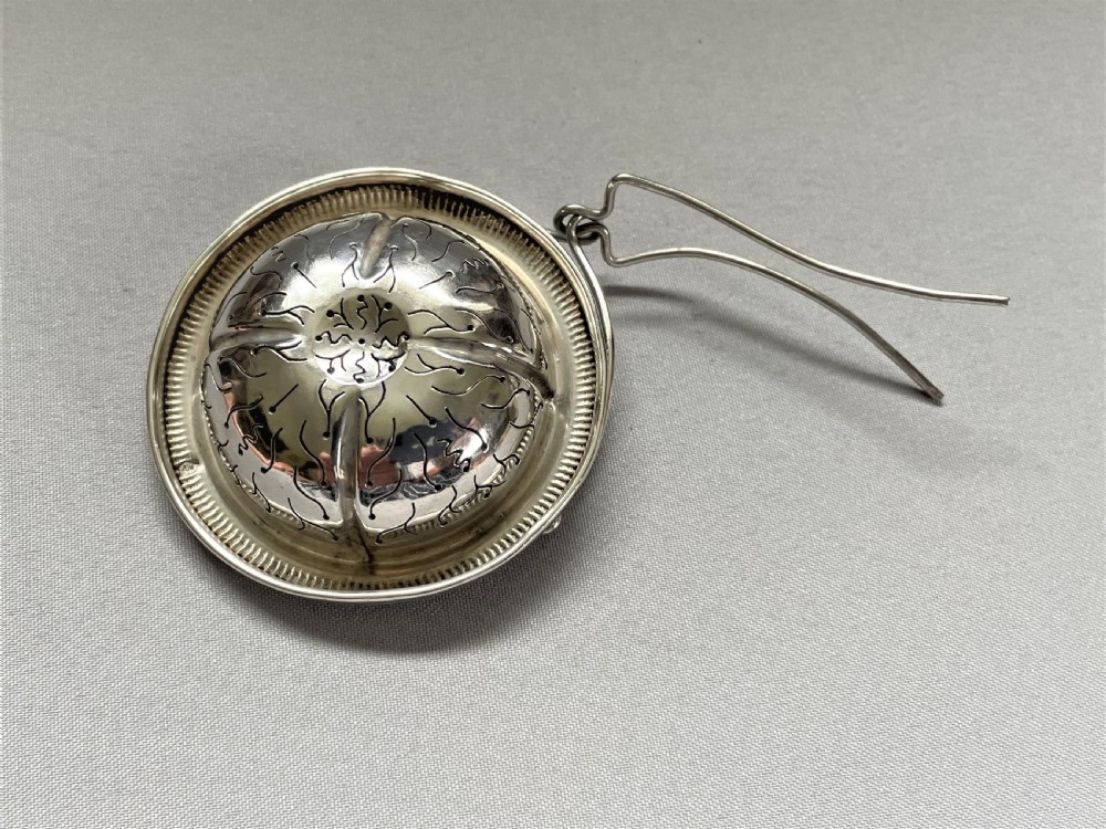 A charming French silver suspension tea strainer View IV